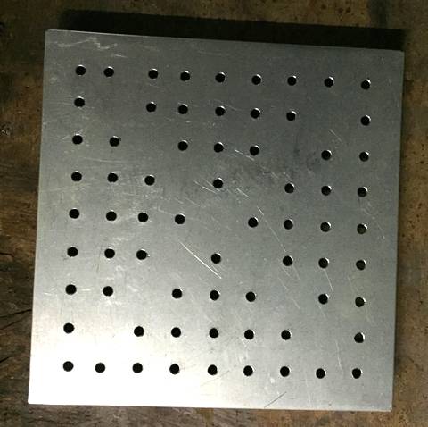 A piece of aluminum perforated sheet with round hole.