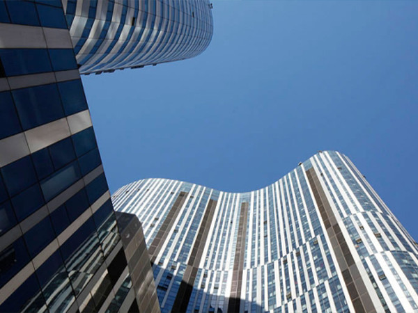 A view from an upward angle of an office building with aluminum panel cladding.