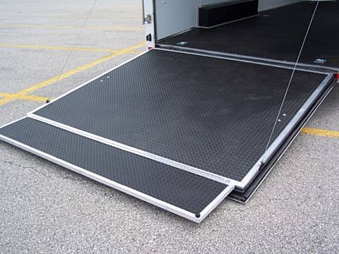 A corner of a truck with a black steel ramp extension.