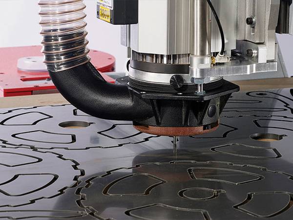 CNC cutting machine is carving complex patterns on aluminum plates.