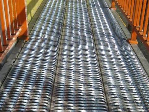 Three rows of diamond safety grating treads lay a walkway.