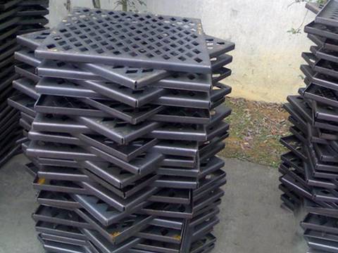 Piles of heavy duty perforated stainless steel sheets with diamond holes