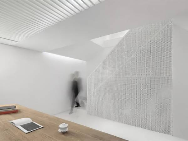 Office partitions are decorated with white perforated metal sheets