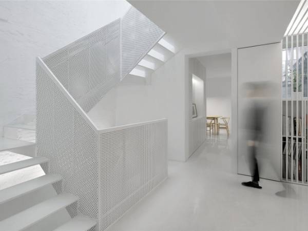 Stairs in the house decorated with white perforated metal sheets