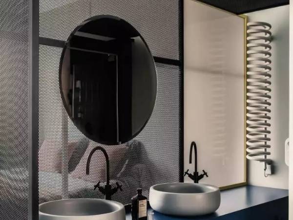 Mirror place in the bathroom is decorated with perforated metal sheets.