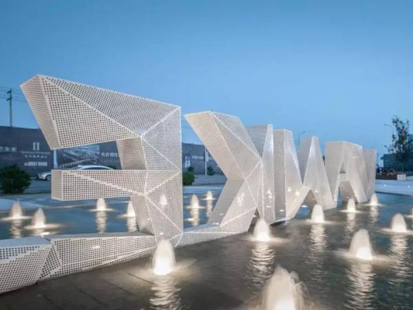 Water surface is equipped with letters made of white perforated metal sheets.