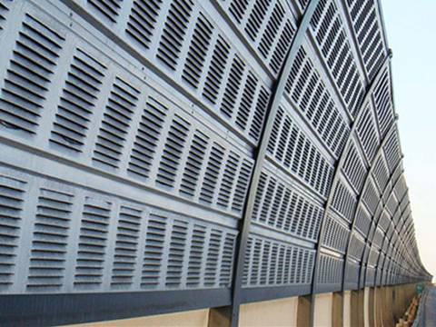 Arc-shaped noise barriers are installed on the highway.