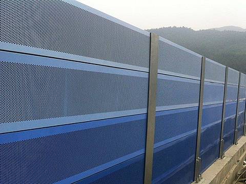 Blue noise barriers are installed on the highway.