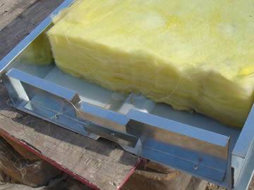 Several pieces of glass wool are placed into the noise barrier.