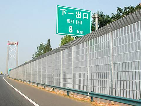 Top Knuckling shaped noise barriers are installed on the highway.