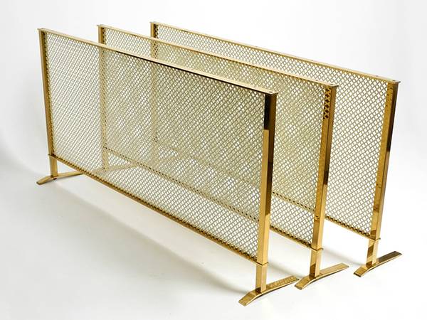 3 screens made of perforated brass sheets are arranged together.