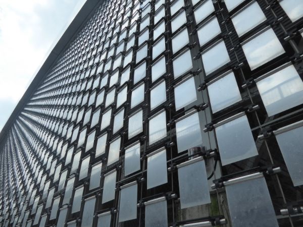 A building facade is covered with perforated kinetic facade.