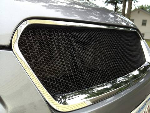 A black perforated mesh grill of a car made of hex hole perforated sheet