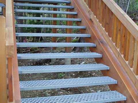 Perforated anti-skid planks are built stair treads.