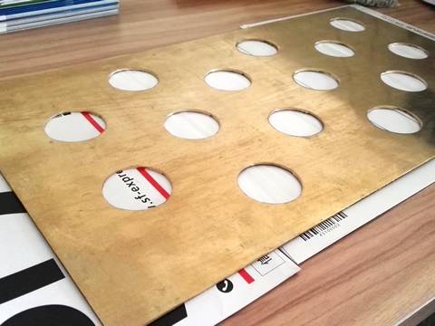 There is one single perforated brass sheet on the table, with fifteen perforated holes.