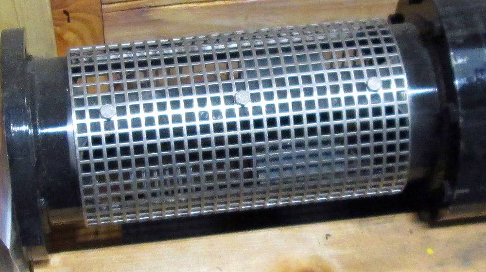 A tube shape strainer is made of stainless steel perforated sheet with square holes.